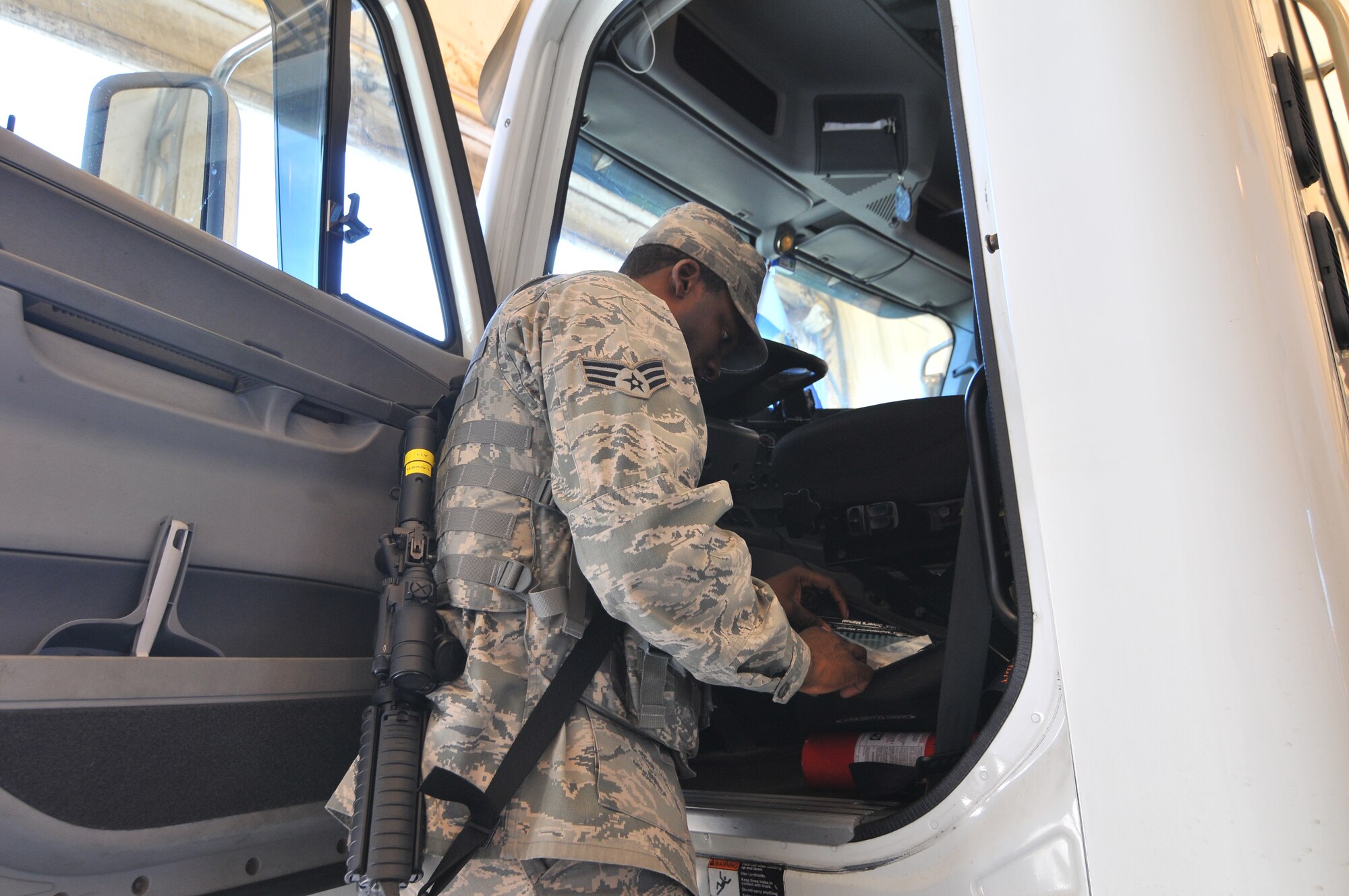 A picture of U.S. Air Force Senior Airman Henry Lanier, with the New Jersey Air National Guard's 177th Maintenance Squadron, inspecting a commercial vehicle entering the Atlantic City Air National Guard Base.