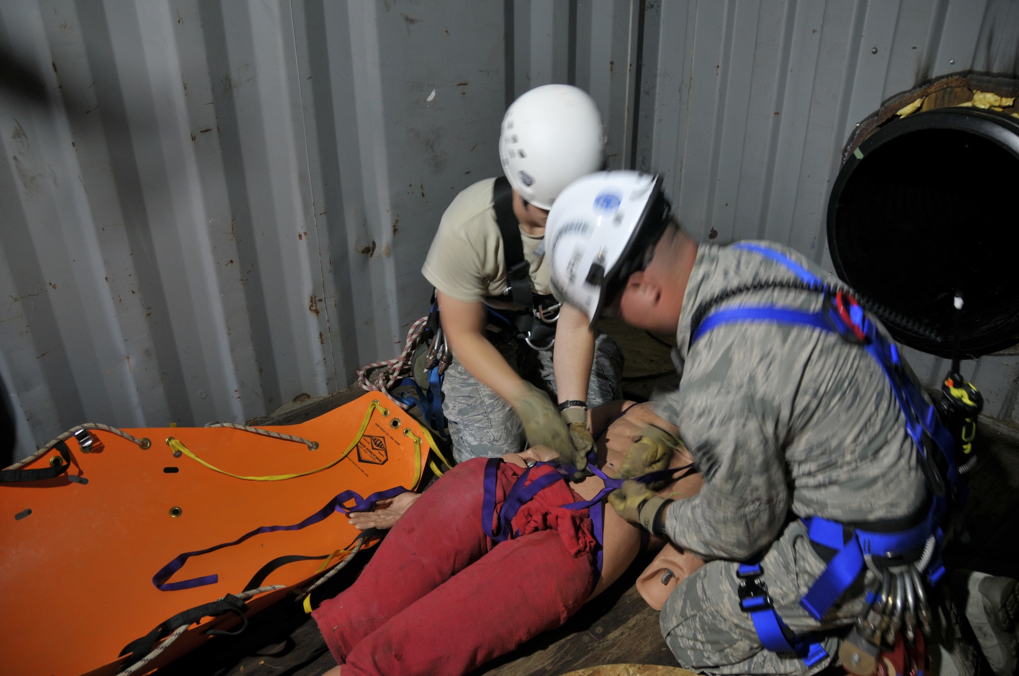 Staff Sgt. Jennifer Bristol and Staff Sgt. Christopher Meyer prepare a victim for rescue during confined space training for the 109th Fire Department's search and rescue team at Stratton Air National Guard Base, New York, on Sept. 17, 2015. The 12-person search and rescue team trains monthly on various rescue techniques. (U.S. Air National Guard photo by Tech. Sgt. Catharine Schmidt/Released)