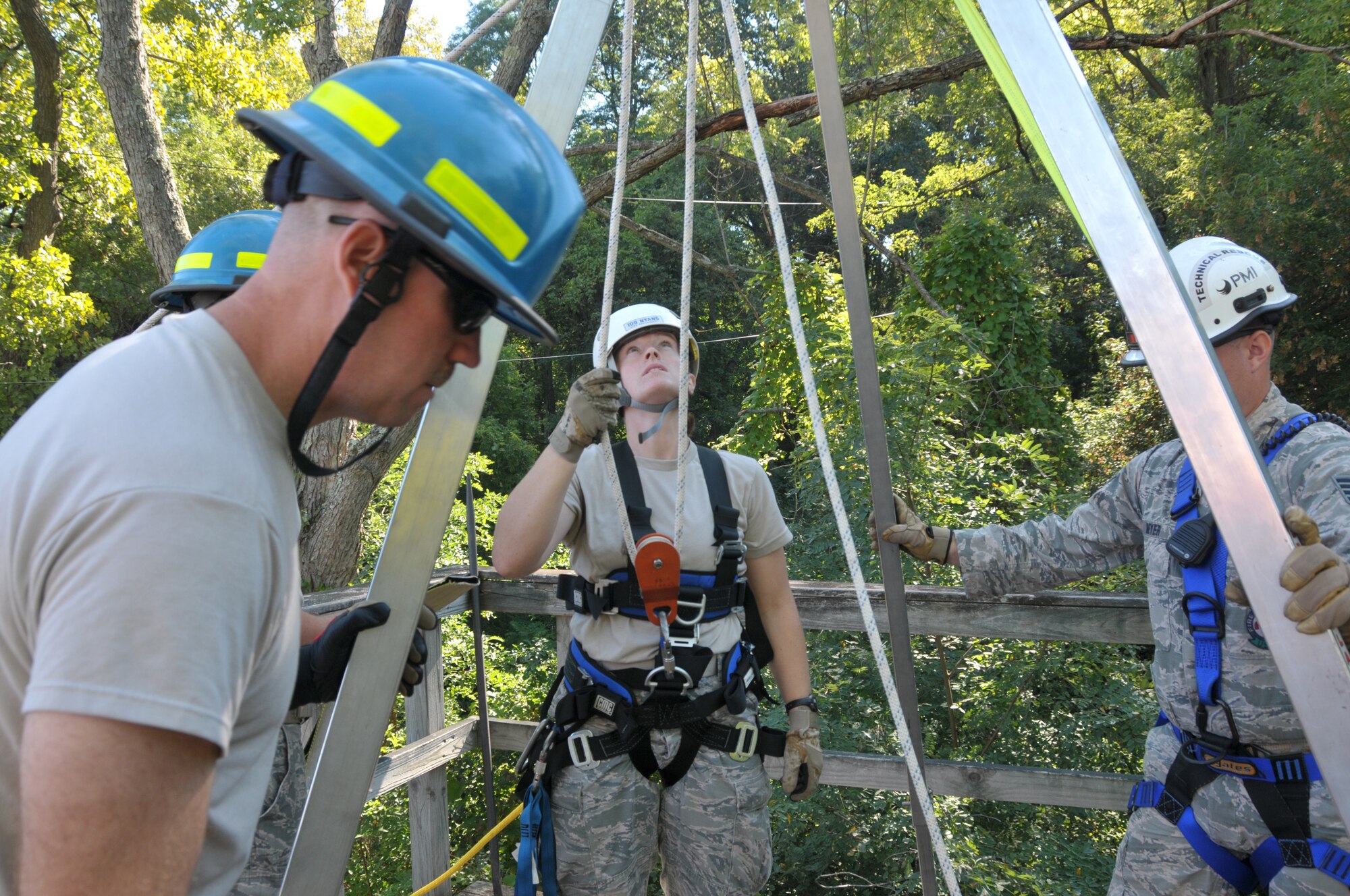 The 109th Fire Department's search and rescue team prepare to lower Staff Sgt. Jennifer Bristol during confined space training for the team at Stratton Air National Guard Base, New York, on Sept. 17, 2015. The 12-person search and rescue team trains monthly on various rescue techniques. (U.S. Air National Guard photo by Tech. Sgt. Catharine Schmidt/Released)