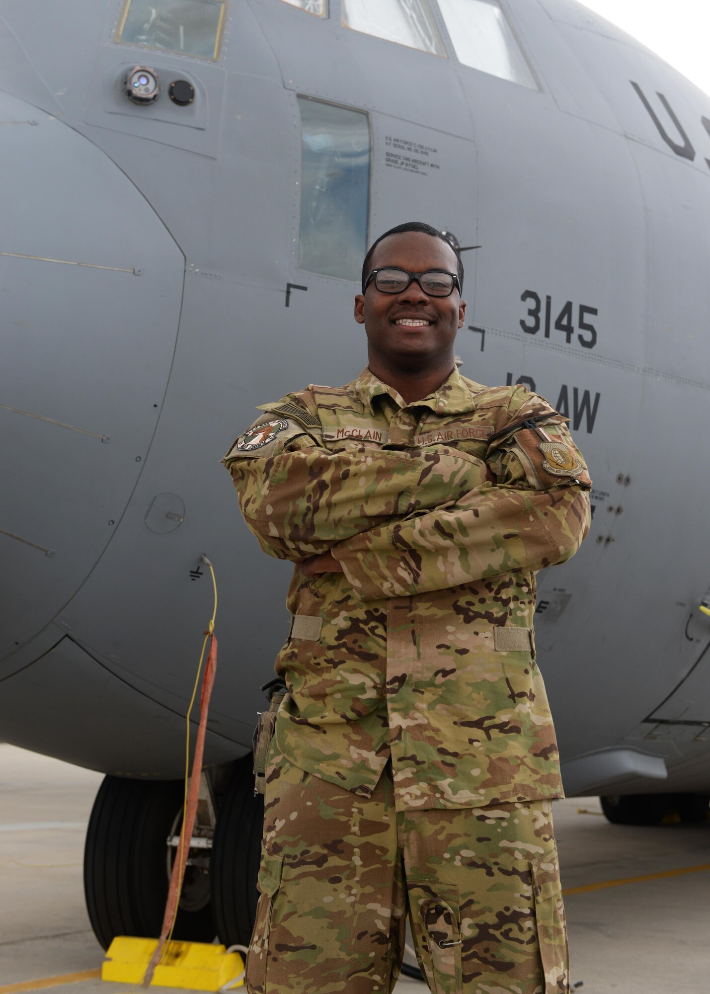 U.S. Air Force Capt. Boston McClain, 774th Expeditionary Airlift Squadron C-130J Super Hercules pilot poses for a photo in front of an aircraft Sep. 4, 2015, at Bagram Airfield, Afghanistan. McClain is responsible for transporting mission essential assets as well as passengers to various forward operating bases throughout Afghanistan. (U.S. Air Force photo by Senior Airman Cierra Presentado/Released)