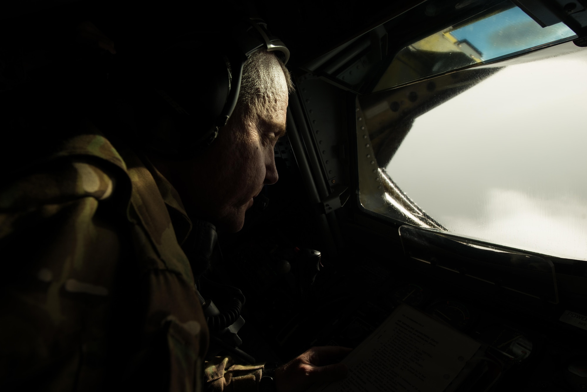 Senior Master Sgt.  Barry, 340th Expeditionary Air Refueling Squadron boom operator, looks out a boom pod window after refueling aircraft over Iraq September 16, 2015. (U.S. Air Force photo/Staff Sgt. Alexandre Montes)  