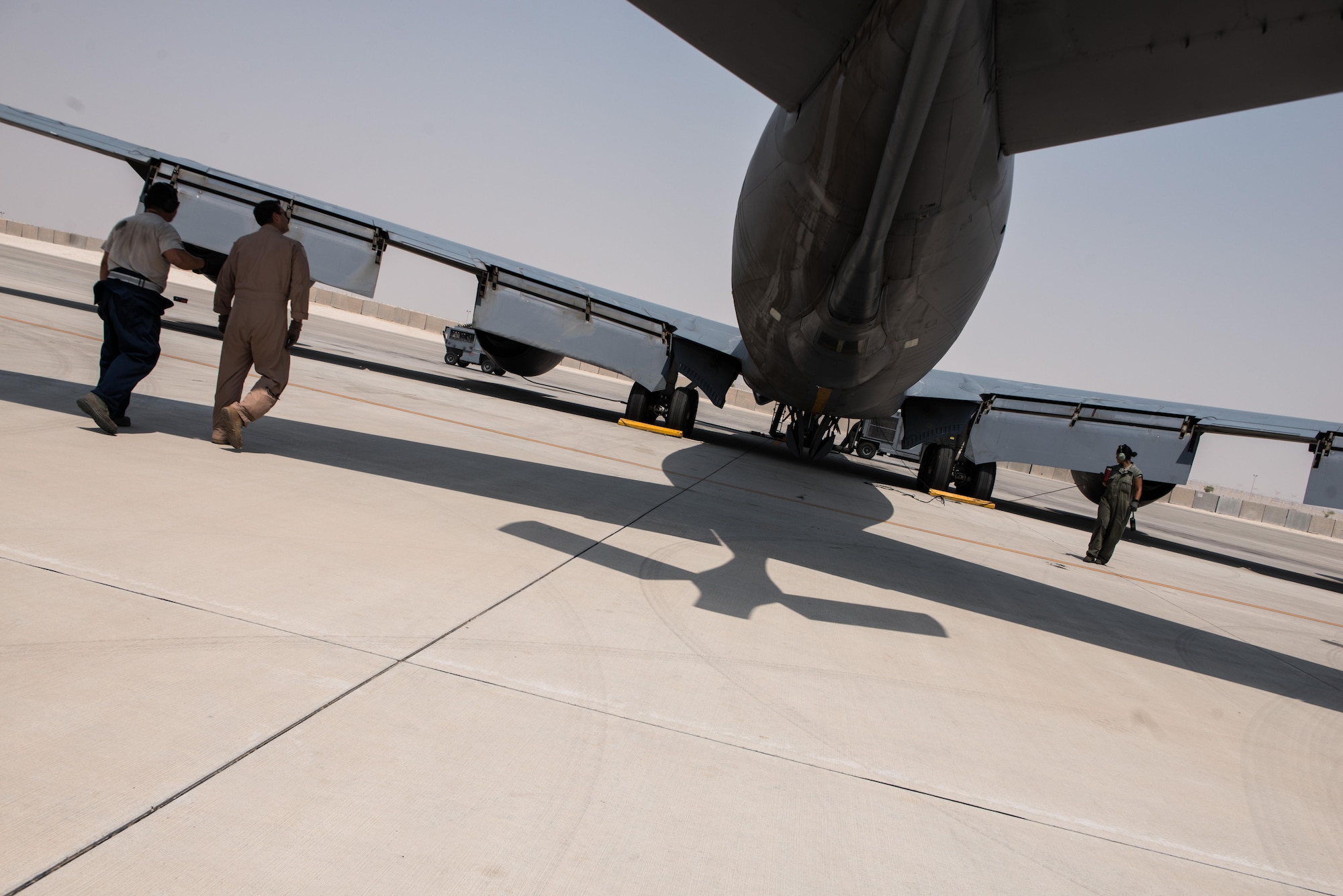 Captain Daniel, 340th Expeditionary Air Refueling Squadron, inspects the exterior of a KC-135 Stratotanker with Senior Airman Edwin Carvajal, 340th Aircraft Maintenance Unit, during final inspections prior to take off September 16, 2015 at Al Udeid Air Base, Qatar. (U.S. Air Force photo/Staff Sgt. Alexandre Montes)