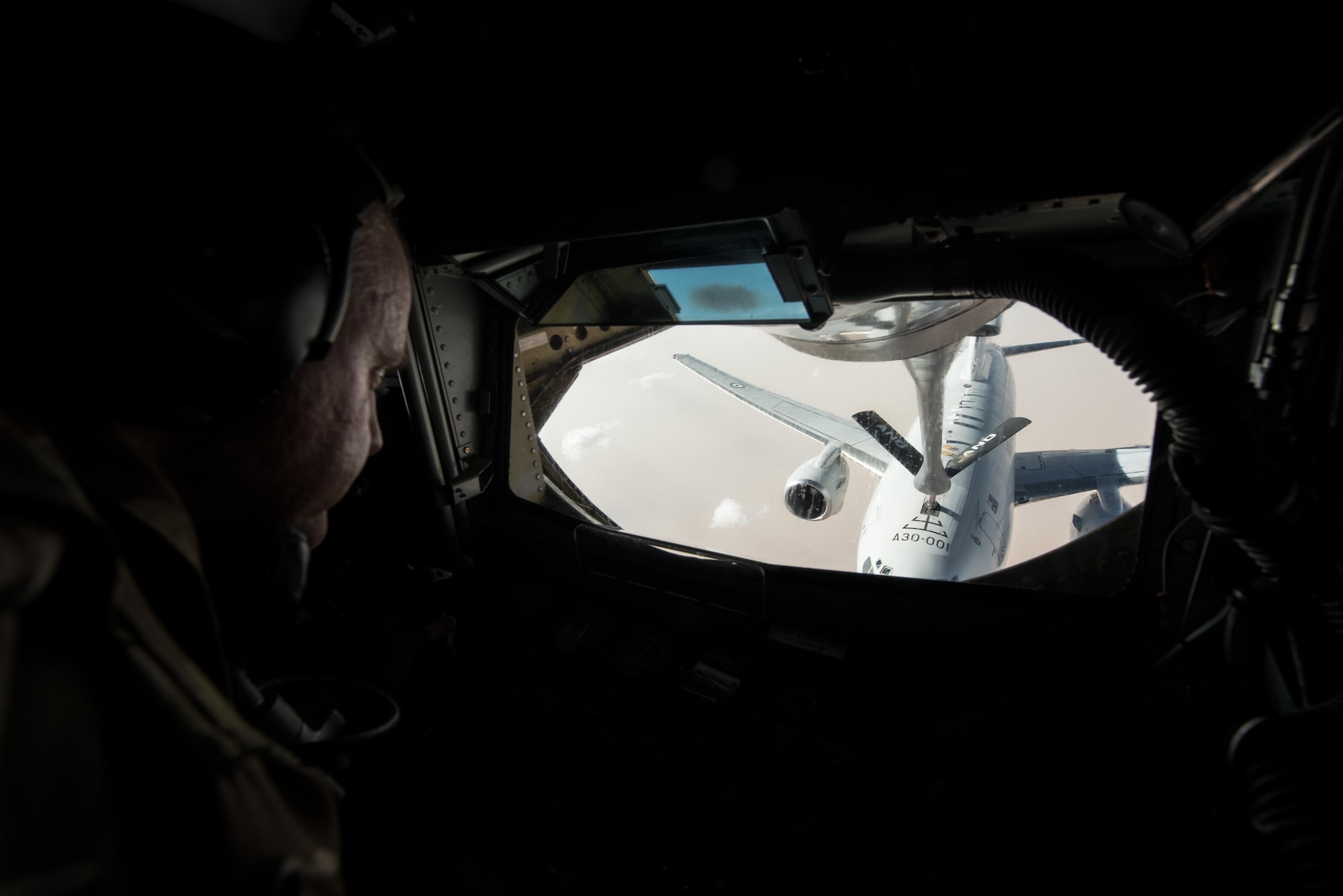 Senior Master Sgt.  Barry, 340th Expeditionary Air Refueling Squadron boom operator, guides a boom pod to a Royal Australian Air Force E-7A Wedgetail over Iraq September 16, 2015. (U.S. Air Force photo/Staff Sgt. Alexandre Montes)  
