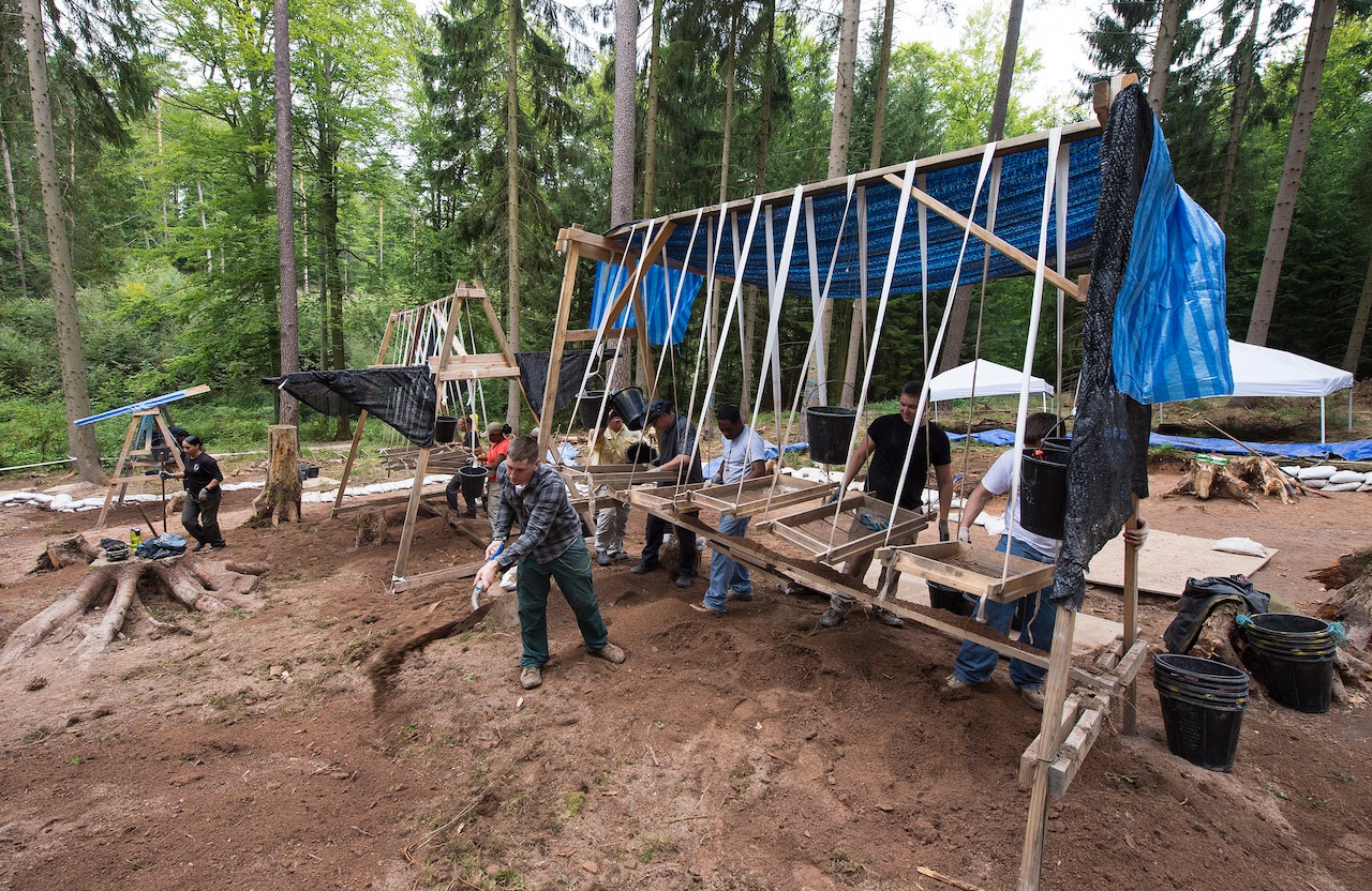 Members of a Defense POW/MIA Accounting Agency recovery team excavate and screen for material evidence during a DPAA recovery mission located near Riechelsdorf, Germany, Sept. 1, 2015. The team is in search of five U.S. airmen who were lost in a B-24 crash during World War II in an effort to properly identify the services members and return their remains to the United States. DoD photo by U.S. Air Force Staff Sgt. Brian Kimball
