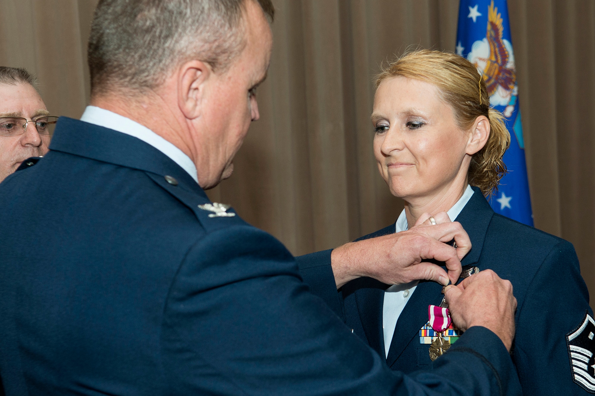 U.S. Air Force Col. Bruce Cox, 307th Bomb Wing commander, awards the Air Force Meritorious Service Medal to Master Sgt. Kay Lachney during a commander's call on Sept. 13, 2015, Barksdale Air Force Base, La. Lachney received the medal for outstanding achievement while deployed in support of Operation Enduring Freedom as the First Sergeant of the 451st Expeditionary Aircraft Maintenance Squadron, Kandahar Airfield, Afghanistan. (U.S. Air Force photo by Master Sgt. Greg Steele/Released)