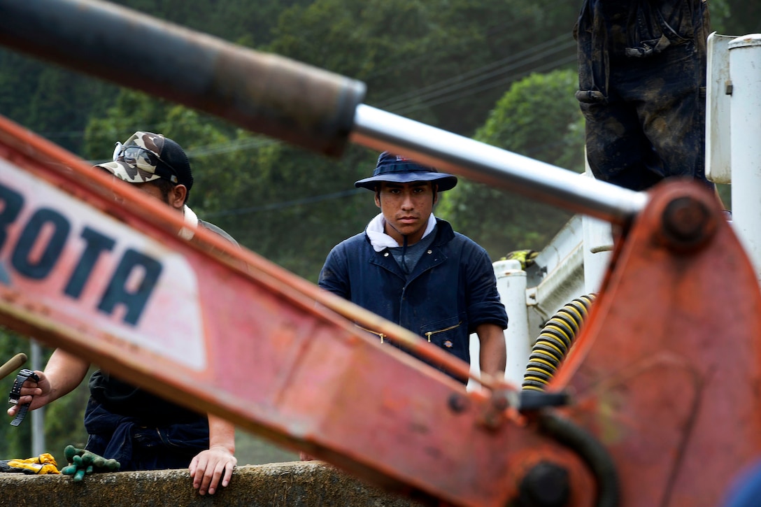 Japanese volunteers take a break from digging mud during flood relief at Kanuma City, Tochigi Prefecture, Japan, Sept. 15, 2015. The volunteers are assigned to the 374th Civil Engineer Squadron. U.S. Air Force photo by Staff Sgt. Cody H. Ramirez