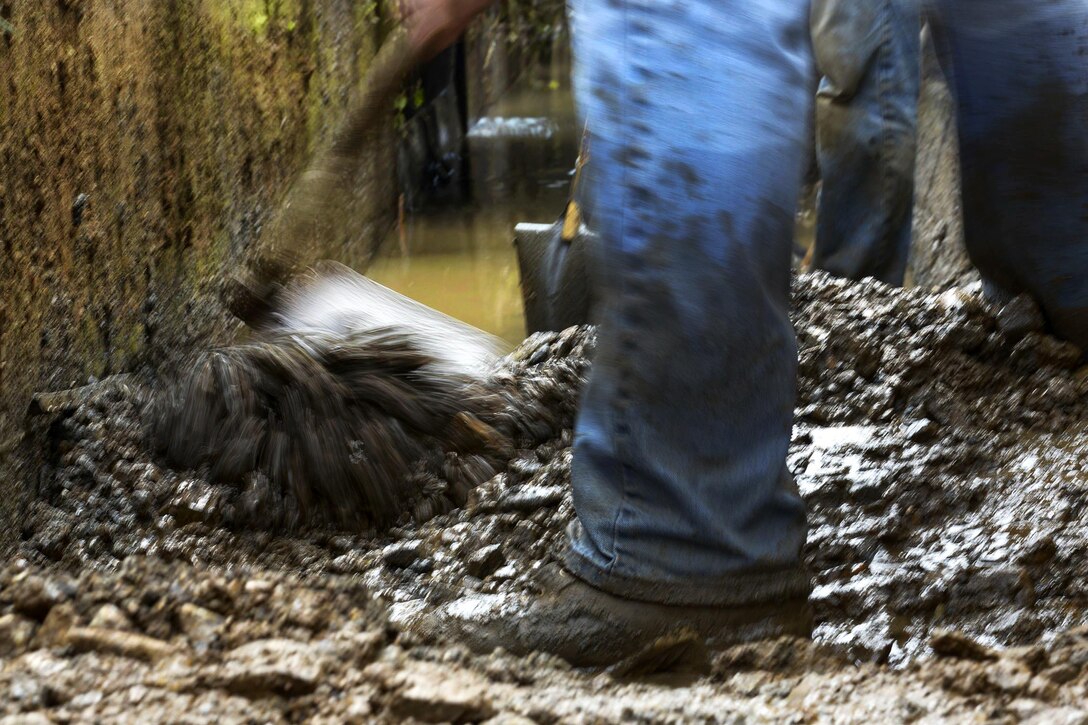 Volunteers scrape mud into a pile to clear an irrigation drain at Kanuma City, Tochigi prefecture, Sept. 15, 2015. U.S. Air Force photo by Staff Sgt. Cody H. Ramirez 



