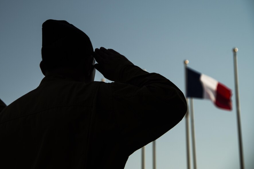 A Combined Air Operations Center member salutes the French Flag during the French National Day Parade September 14, 2015 at Al Udeid Air Base, Qatar. The parade was the commemoration of the death of WWI French pilot Capt Georges Guynemer, in Polkapelle, on September 11th, 1917. Since 1923, the French Air Force has organized a parade to start or close the day in remembrance of him.  (U.S. Air Force photo by Tech. Sgt. Rasheen Douglas)