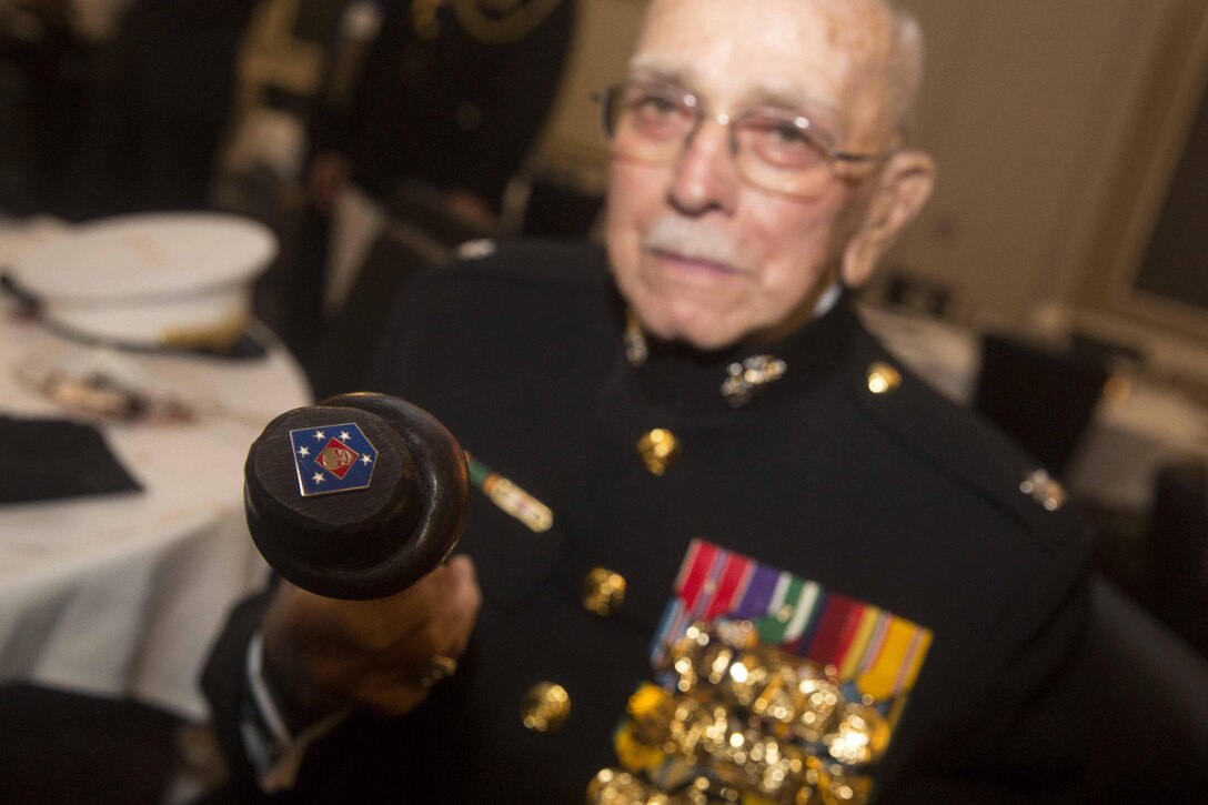 Lt. Col. Jack R. Christensen, retired, a World War II Marine Raider, holds a handmade staff under his arm at the 2015 Marine Raider Reunion in San Antonio, Aug. 30, 2015. An active duty Raider with U.S. Marine Corps Forces, Special Operations Command whittled the staff himself, and included an ornate Raider insignia from World War II, as well as the MARSOC insignia into the walking-stick’s design. He donated the staff to the U.S. Marine Raider Association and Foundation to be used by a Raider in need of assistance while walking. (U.S. Marine Corps photo by Cpl. Steven Fox/Released)