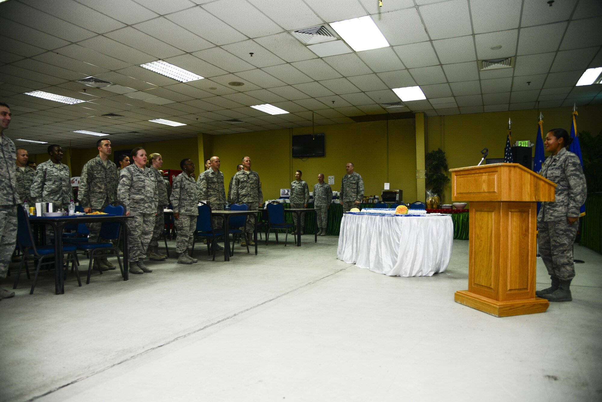 Airmen in the Independence Dining Facility stand at attention singing the Air Force Song during the cake cutting ceremony Sept. 18, 2015, at Al Udeid Air Base, Qatar. The cake cutting ceremony is traditionally performed by the oldest and youngest Airman. This year marks 68 years of military superiority through air power. (U.S. Air Force photo by Tech. Sgt. Rasheen Douglas)