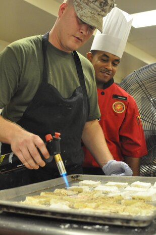 Sgt. Nicholas Frederick and Sgt. Nicholas Graham, quality assurance evaluators for Base Food Service, participate in the Chef of the Quarter Competition at the Bruce Hall dining facility, Sept. 10.