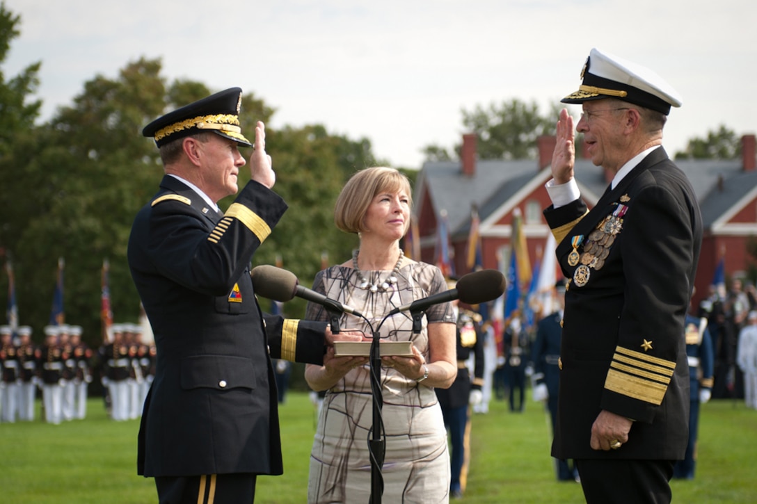 Army Gen. Martin E. Dempsey, left, takes the oath of office to become the 18th chairman of the Joint Chiefs of Staff as his wife, Deanie, stands by during a ceremony on Joint Base Myer-Henderson Hall, Va., Sept. 30, 2011.