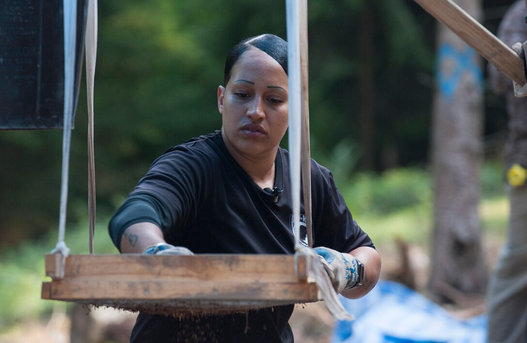 U.S. Army Sgt. 1st Class Nakischa Adams screens dirt in search of material evidence during a DPAA recovery mission located near Riechelsdorf, Germany, Sept. 1, 2015. Adams is a mortuary affairs specialist and team sergeant assigned to the Defense POW/MIA Accounting Agency. The team is in search of five U.S. airmen who were lost in a B-24 crash during World War II in an effort to properly identify the service members and return their remains to the United States. DoD photo by U.S. Air Force Staff Sgt. Brian Kimball      