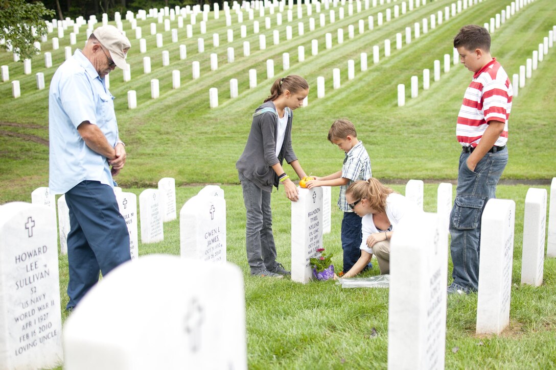 The family of Cpl. Brandon Nylund visits his gravesite at the Quantico National Cemetery following the Honor and Remember Memorial Ceremony in the Town of Quantico, Sept 10. Nylund committed suicide March 7, 2010, only one year after separating from the Marine Corps.