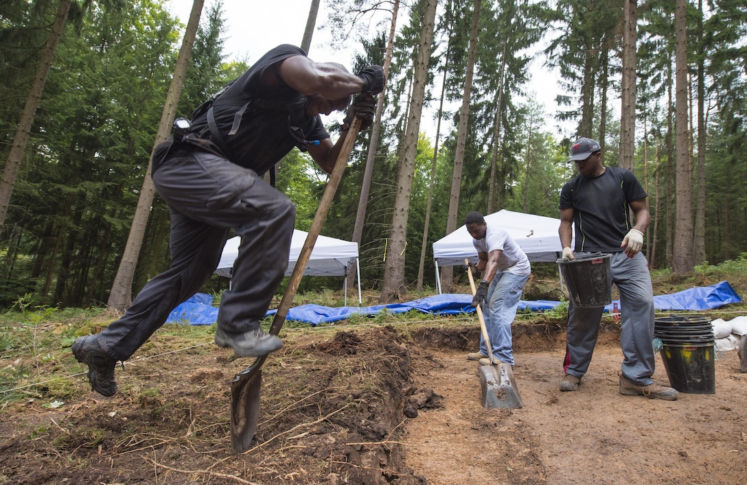 Members of a Defense POW/MIA Accounting Agency excavate a site during a recovery mission located near Riechelsdorf, Germany, Sept. 1, 2015. DoD photo by U.S. Air Force Staff Sgt. Brian Kimball