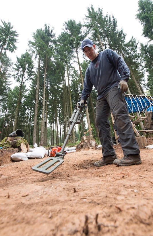 U.S. Air Force Master Sgt. Dennis Gage sweeps the ground with a metal detector during a Defense POW/MIA Accounting Agency recovery excavation near Riechelsdorf, Germany, Sept. 10, 2015. DoD photo by U.S. Air Force Staff Sgt. Brian Kimball
