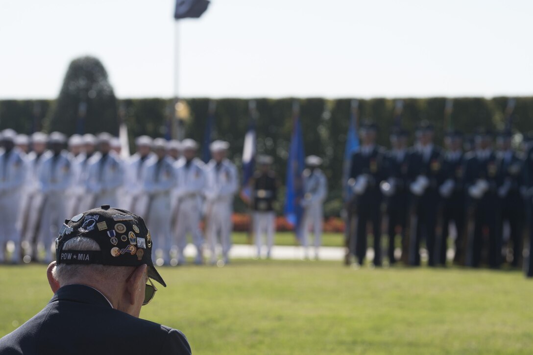 A guest at the Prisoner of War, Missing in Action National Recognition Day ceremony listens as Defense Secretary Ash Carter delivers remarks at the Pentagon, Sept. 18, 2015. 