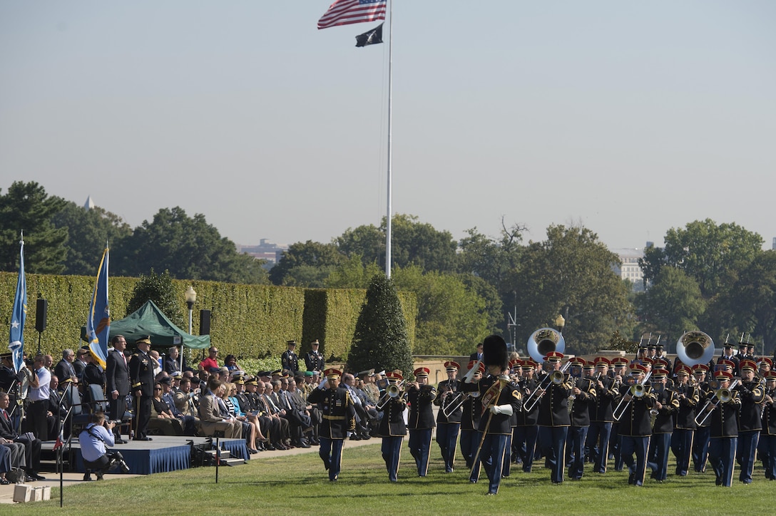 The Army Band marches past Defense Secretary Ash Carter and Army Gen. Martin Dempsey, chairman of the Joint Chiefs of Staff, during a pass and review at the Prisoner of War, Missing in Action National Recognition Day ceremony at the Pentagon, Sept. 18, 2015. 