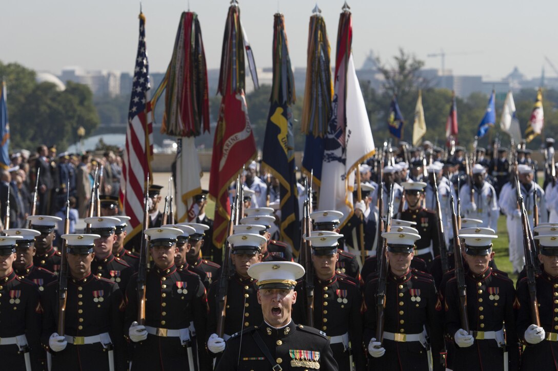 Soldiers and Marines march past Defense Secretary Ash Carter and Army Gen. Martin Dempsey, chairman of the Joint Chiefs of Staff, during a pass and review at the Prisoner of War, Missing in Action National Recognition Day ceremony at the Pentagon, Sept. 18, 2015. 