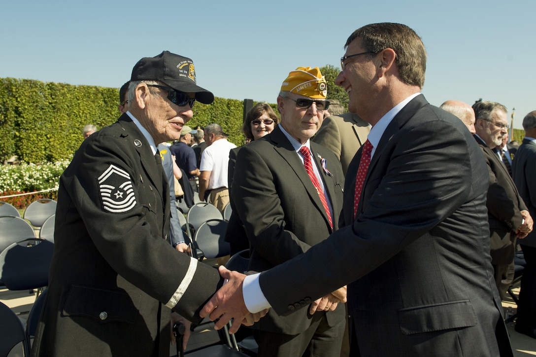 Defense Secretary Ash Carter speaks with guests following the Prisoner of War / Missing in Action National Recognition Day ceremony at the Pentagon River Terrace Parade Field, Sept. 18, 2015. DoD photo by Senior Master Sgt. Adrian Cadiz