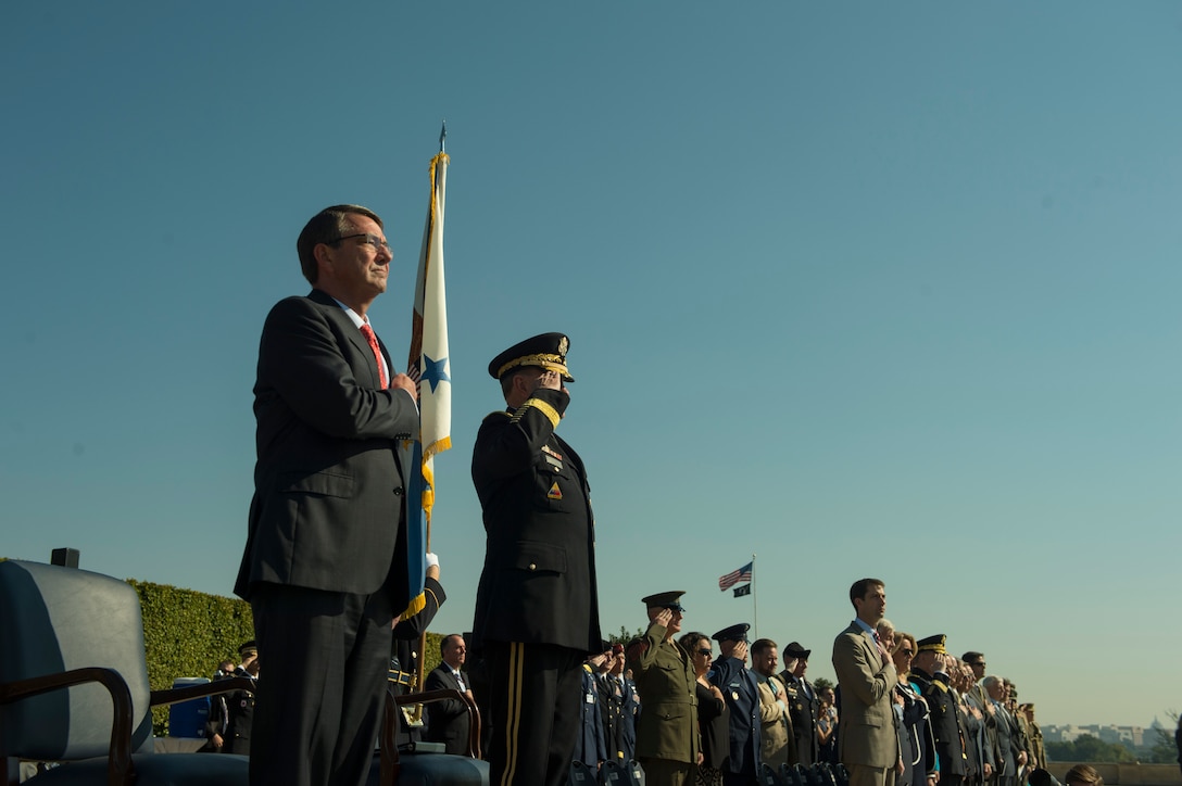 Defense Secretary Ash Carter and Army Gen. Martin Dempsey,  chairman of the Joint Chiefs of Staff, render honors during the playing of the national anthem during the Prisoner of War, Missing in Action National Recognition Day ceremony at the Pentagon , Sept. 18, 2015. 