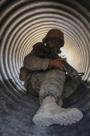 Recruit Julian J. Lara, Kilo Company, 3rd Recruit Training Battalion, slides through a tunnel during the Leadership Reaction Course at Marine Corps Base Camp Pendleton, Calif., Sept. 9.  Following graduation, Lara will attend the School of Infantry for Marine Combat Training in Camp Pendleton, Calif., and after will pursue a career in aviation electronics and plans on trying to commission as an officer sometime in the next few years.  Today, all male recruits recruited from recruiting stations west of the Mississippi are trained at MCRD San Diego. The depot is responsible for training more than 16,000 recruits annually. Kilo Company graduated recruit training Sept. 18.
