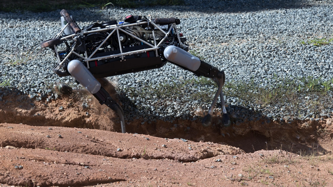 Spot", a quadruped prototype robot, maneuvers through a ditch during a demonstration at Marine Corps Base Quantico, Va.,Sept. 16, 2015. Employees of the Defense Advanced Research Projects Agency trained Marines from the Marine Corps Warfighting Lab how to operate “Spot”.