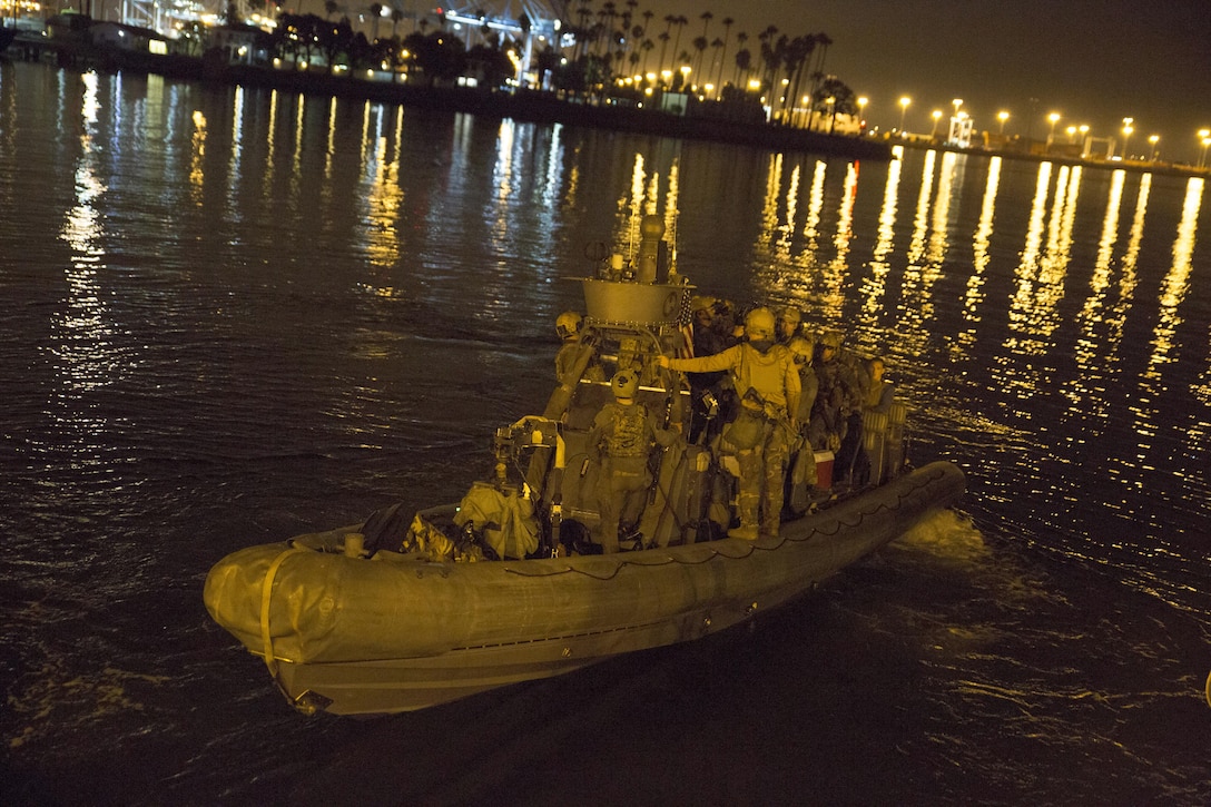 A Marine Raider with 1st Marine Raider Battalion, U.S. Marine Corps Forces, Special Operations Command, transitions out of the water during a simulated underwater assault force night-raid in Los Angeles, California, Sept. 3, 2015. Training like this is conducted to meet Special Operations Forces dive requirements, and to enhance the understanding, planning and operational considerations when working in a joint operational environment with both special operations and conventional Marine Corps forces. 1st Marine Raider Battalion is organized, trained and equipped to deploy for worldwide missions as directed by MARSOC in support of their regionally-aligned Theater Special Operations Command.