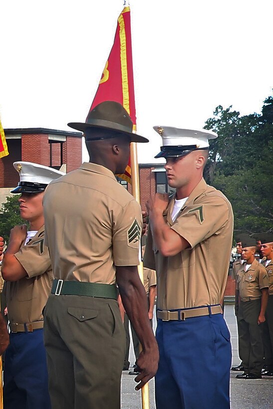 Pfc. Kameron B. Whitaker, honor graduate of platoon 1078, retires the guidon to his Drill Instructor during graduation Sept. 18, 2015 at Marine Corps Recruit Depot Parris Island, S.C.  Whitaker, a native of Colquitt, Ga., was recruited by Staff Sgt. Chase V. Morrison out of Recruiting Station Montgomery. Recruit training signifies the transformation of a civilian to a United States Marine. Upon graduation, the newly-minted Marines will receive ten days of leave before attending the School of Infantry East, Camp Geiger, N.C. The Marine will be trained in basic infantry skills to ensure Marines are combat-ready. (Official Marine Corps photo by Cpl. John-Paul Imbody)