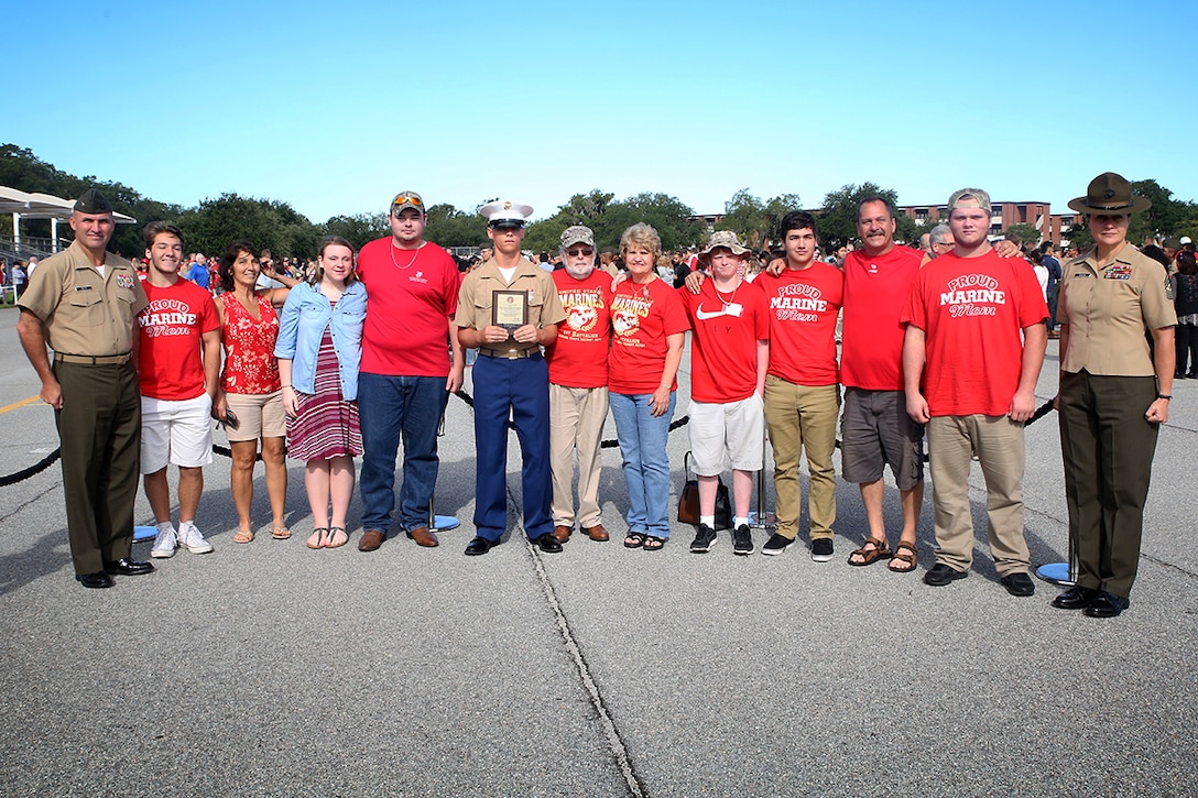 Pfc. Hayden T. Boyles, honor graduate of platoon 1076, poses for a photo with his family, Col. Jeffrey W. Fultz and Sgt. Maj. Angela M. Maness after recruit graduation Sept. 18, 2015 at Marine Corps Recruit Depot Parris Island, S.C.  Boyles, a native of Greenbrier, TN., was recruited by Sgt. Alexey G. Rivera out of Recruiting Station Nashville. After three months of boot camp, the new Marines have earned 10 days of leave to spend at home before attending the School of Infantry East, Camp Geiger, N.C., for a month. Fultz is the Chief of Staff of Eastern Recruiting Region Parris Island. Maness is the Sergeant Major of Marine Corps Recruit Depot Parris Island, S.C. (Official Marine Corps photo by Cpl. John-Paul Imbody)