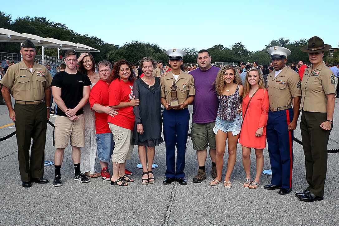 Pfc. Francis X. Santore III, honor graduate of platoon 1073, stands with his family, Col. Jeffrey W. Fultz and Sgt. Maj. Angela M. Maness after recruit graduation Sept. 18, 2015 at Marine Corps Recruit Depot Parris Island, S.C. Recruit training signifies the transformation of a civilian to a United States Marine. Upon graduation, the newly-minted Marines will receive ten days of leave before attending the School of Infantry East, Camp Geiger, N.C. The Marine will be trained in basic infantry skills to ensure Marines are combat-ready. Santore, a native of Fort Mill, S.C., was recruited by Sgt. Eric L. Rogers from Recruiting Station Columbia. Fultz is the Chief of Staff of Eastern Recruiting Region Parris Island. Maness is the Sergeant Major of Marine Corps Recruit Depot Parris Island, S.C. (Official Marine Corps photo by Cpl. John-Paul Imbody)