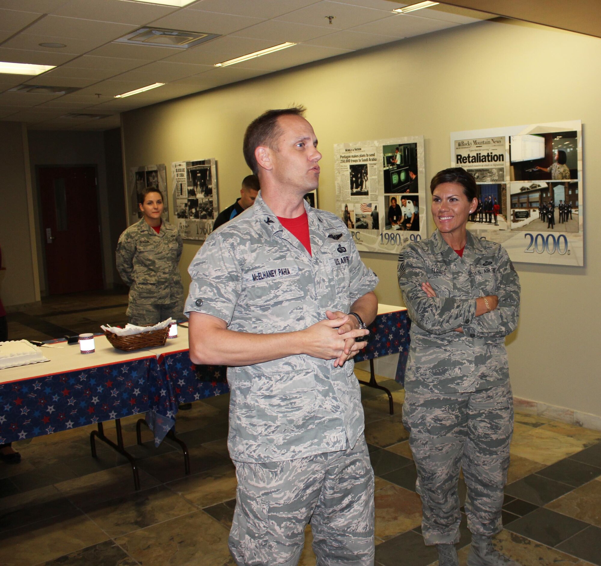 Col. Sean McElhaney Pahia, Air Reserve Personnel Center vice commander, and Chief Master Sgt. Ruthe Flores, ARPC command chief, speak to service members and employees before cutting two ceremonial cakes in recognition of the U.S. Air Force’s 68th birthday and National POW/MIA Recognition Day Sept. 18, 2015, at the Air Reserve Personnel Center on Buckley Air Force Base, Colo. (U.S. Air Force photos/Tech. Sgt. Rob Hazelett)