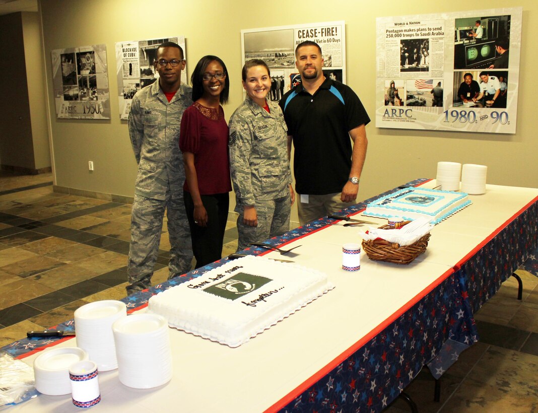 Senior Airman Marqui King, Air Reserve Personnel Center reserve assignment technician, Nikki Johnson, ARPC promotion eligibility human resources assistant, Tech. Sgt. Julia Benson, ARPC assistant personnel systems manager, and Kyle Goldberg, ARPC budget systems analyst, prepare to cut ceremonial cakes in recognition of the U.S. Air Force’s 68th birthday and National POW/MIA Recognition Day Sept. 18, 2015, at the Air Reserve Personnel Center on Buckley Air Force Base, Colo. (U.S. Air Force photos/Tech. Sgt. Rob Hazelett)

