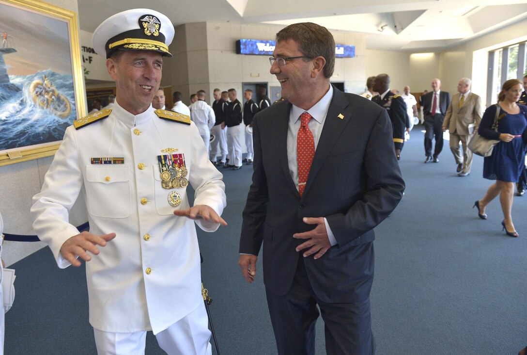 Defense Secretary Ash Carter shares a light moment with the new chief of naval operations, Adm. John Richardson, after a change-of-office ceremony at the U.S. Naval Academy in Annapolis, Md., Sept. 18, 2015. Richardson replaced Adm. Jonathan Greenert, who is retiring after 40 years of service as a naval officer. DoD photo by Glenn Fawcett