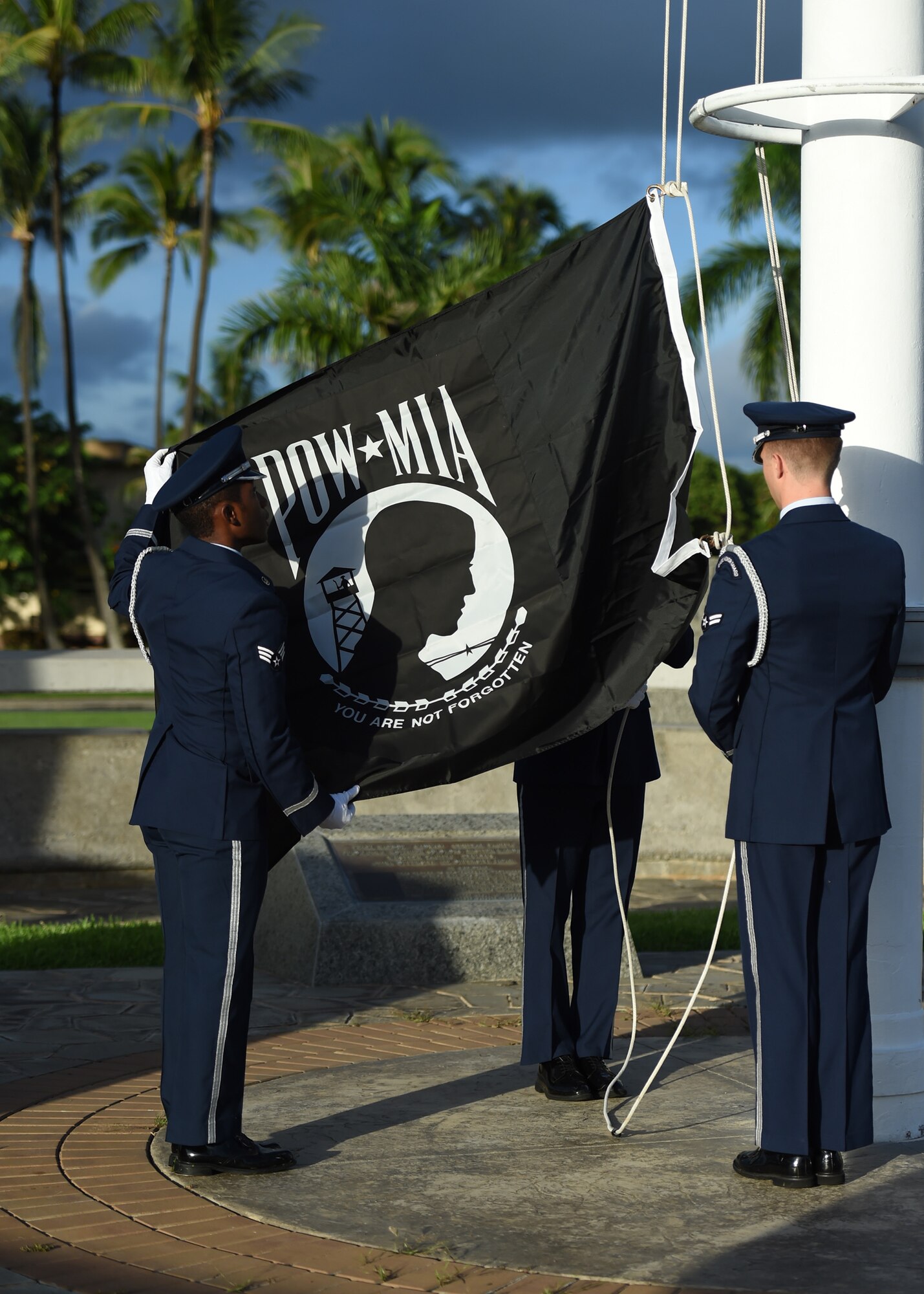 Airmen From Joint Base Pearl Harbor-Hickam’s Honor Guard raise the POW/MIA flag during a POW/MIA revile ceremony, held on JBPHH, Hawaii, Sept. 14, 2015. The ceremony started this year’s POW/MIA week, which honors the 1,627 missing or unaccounted for military members in all branches of armed services. The POW/MIA flag symbolizes the nation’s remembrance of those who were imprisoned while serving in conflicts and those who remain missing. (U.S. Air Force photo by Tech. Sgt. Aaron Oelrich/Released)
