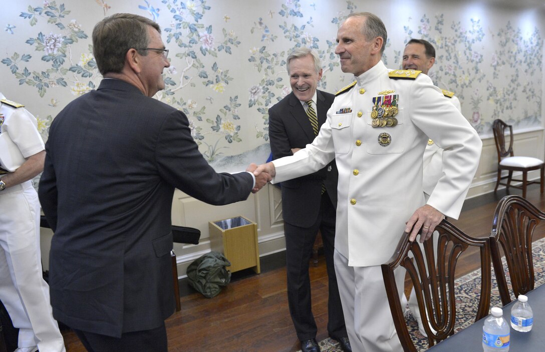 Defense Secretary Ash Carter shakes hands with Adm. Jonathan Greenert, retiring chief of naval operations, prior to a change-of-office ceremony between Greenert and the incoming chief, Adm. John Richardson, at the U.S. Naval Academy in Annapolis, Md., Sept. 18, 2015. DoD Photo by Glenn Fawcett 