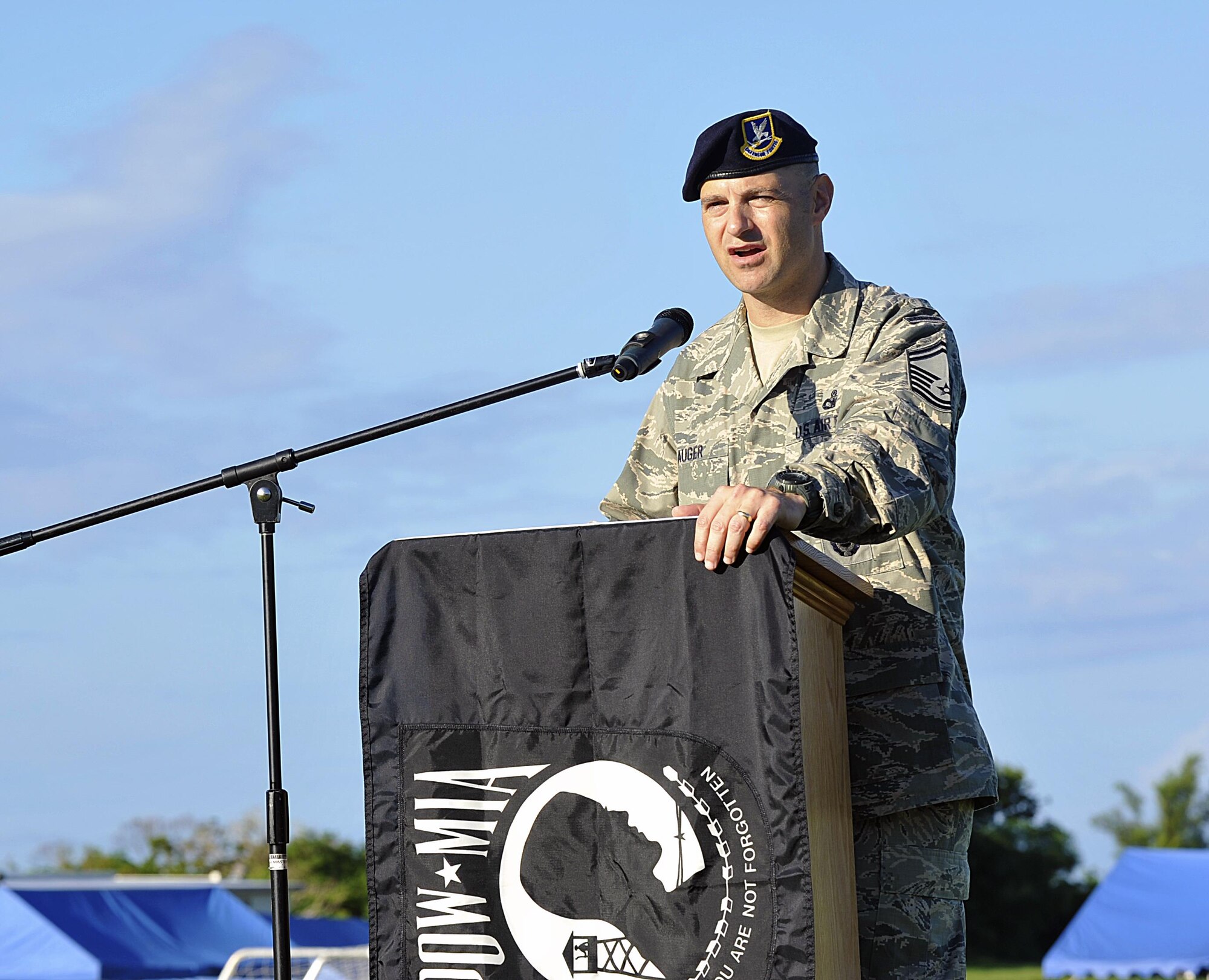 Guest speaker, U.S. Air Force Senior Master Sgt. Jamie Auger, 18th Security Forces Squadron security forces manager, gives opening remarks at Marek Park Sept. 17, 2015, on Kadena Air Base, Japan. Team Kadena honored and highlighted their commitment to prisoners of war and missing in action with a 24-hour vigil run. This event was also open to all Status of Forces Agreement members to honor the POW/MIA. (U.S. Air Force photo by Naoto Anazawa/Released) 