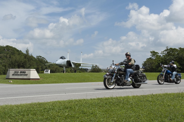 Riders from Kadena’s 2015 Prisoner of War/Missing in Action memorial ride drive past Air Power Park as they exit Kadena Air Base, Japan, on their journey to Cape Zampa, Sept. 18, 2015. Riders came together in support of the memorial ride from not just Kadena Air Base, but surrounding military installations as well. (U.S. Air Force photo by Airman 1st Class Zackary A. Henry/Released)

