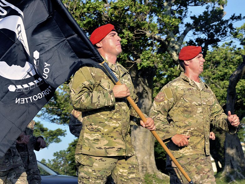 U.S. Air force Master Sgt. David Ibsen, 320th Special Tactics Squadron combat control, leads Airmen in a 24-hour vigil run at Marek Park Sept. 18, 2015, on Kadena Air Base, Japan. More than 600 Team Kadena community members participated in the vigil run with the POW/MIA flag, keeping the flag moving for 24 hours straight in honor of American POWs and MIAs. (U.S. Air Force photo by Naoto Anazawa/Released)