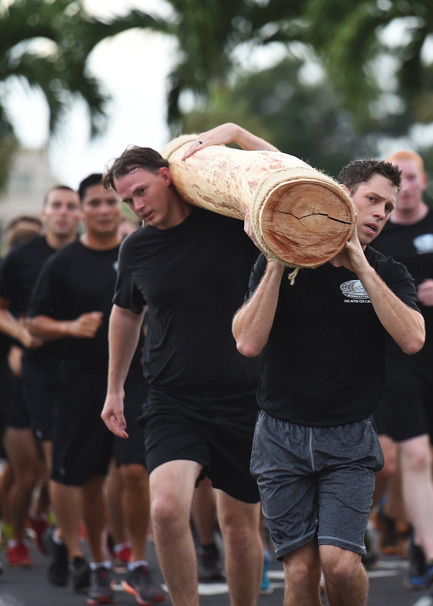Airmen from the 25th Air Support Operations Squadron ran in formation from Earhart track to Atterbury Circle  alternating  caring  the Tactical Air Control Party Loge at the conclusion of the 24 hour Prisoner of War and Missing In Action remembrance run on Joint Base Pearl Harbor-Hickam, Hawaii, Sept. 18, 2015. The 24 hour POW/MIA remembrance run was organized by the 25th Air Support Operations Squadron as a part of POW/MIA week and National POW/MIA Day. Every year the nation pauses on the third Friday of September to remember the sacrifices and service of prisoners of war. There are 83,344 Americans still unaccounted-for across the Defense Department. (U.S. Air Force photo by Tech. Sgt. Aaron Oelrich/Released)   