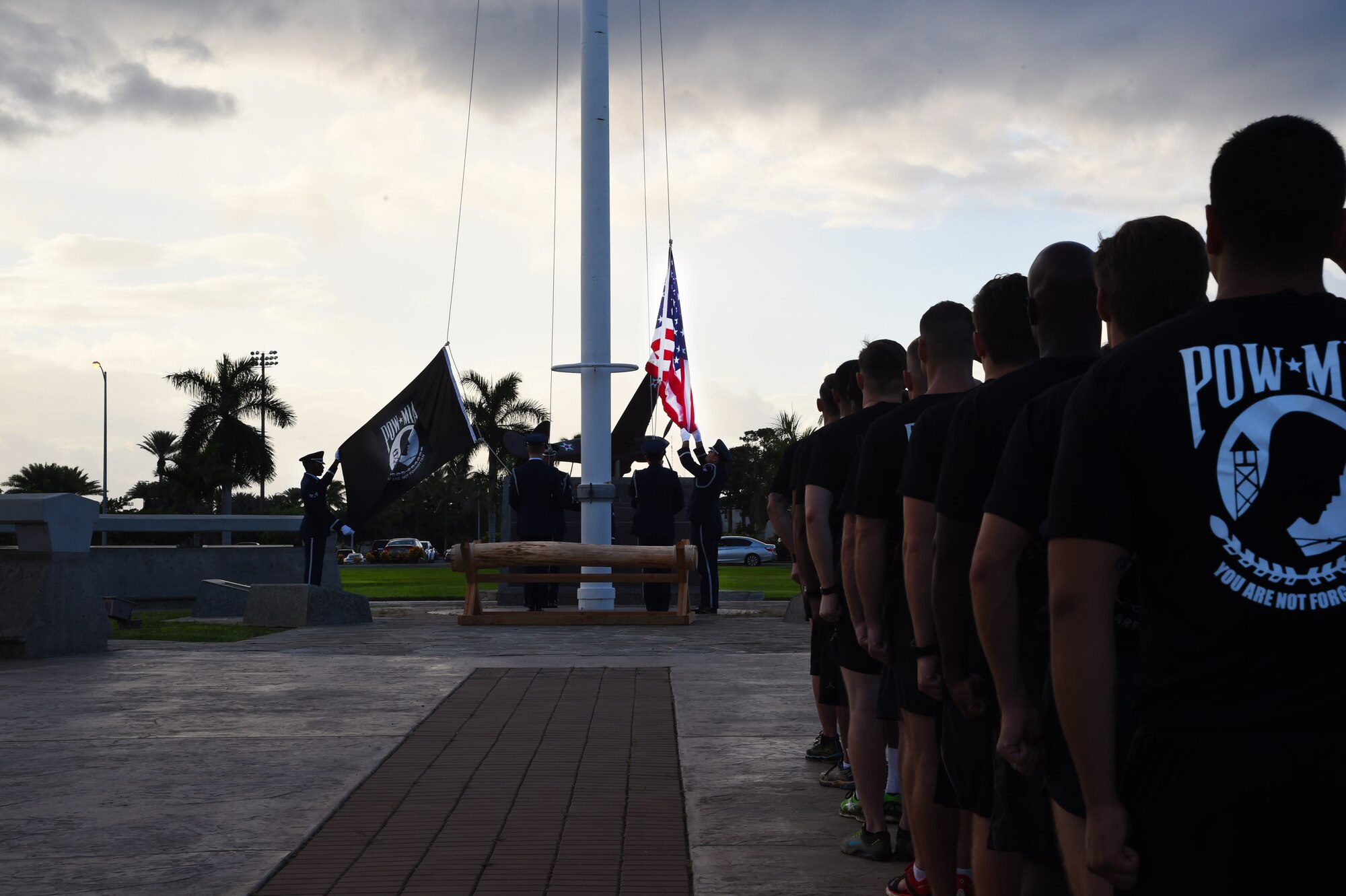 Airmen from the 25th Air Support Operations Squadron salute during the Prisoner of War and Missing In Action reveille ceremony on Joint Base Pearl Harbor-Hickam, Hawaii, Sept. 18, 2015. The 25th ASOS ran in formation from Earhart track to Atterbury Circle at the conclusion of the 24 hour POW/MIA remembrance run to be a part of the reveille ceremony. Every year the nation pauses on the third Friday of September to remember the sacrifices and service of prisoners of war. There are 83,344 Americans still unaccounted-for across the Defense Department. (U.S. Air Force photo by Tech. Sgt. Aaron Oelrich/Released)   