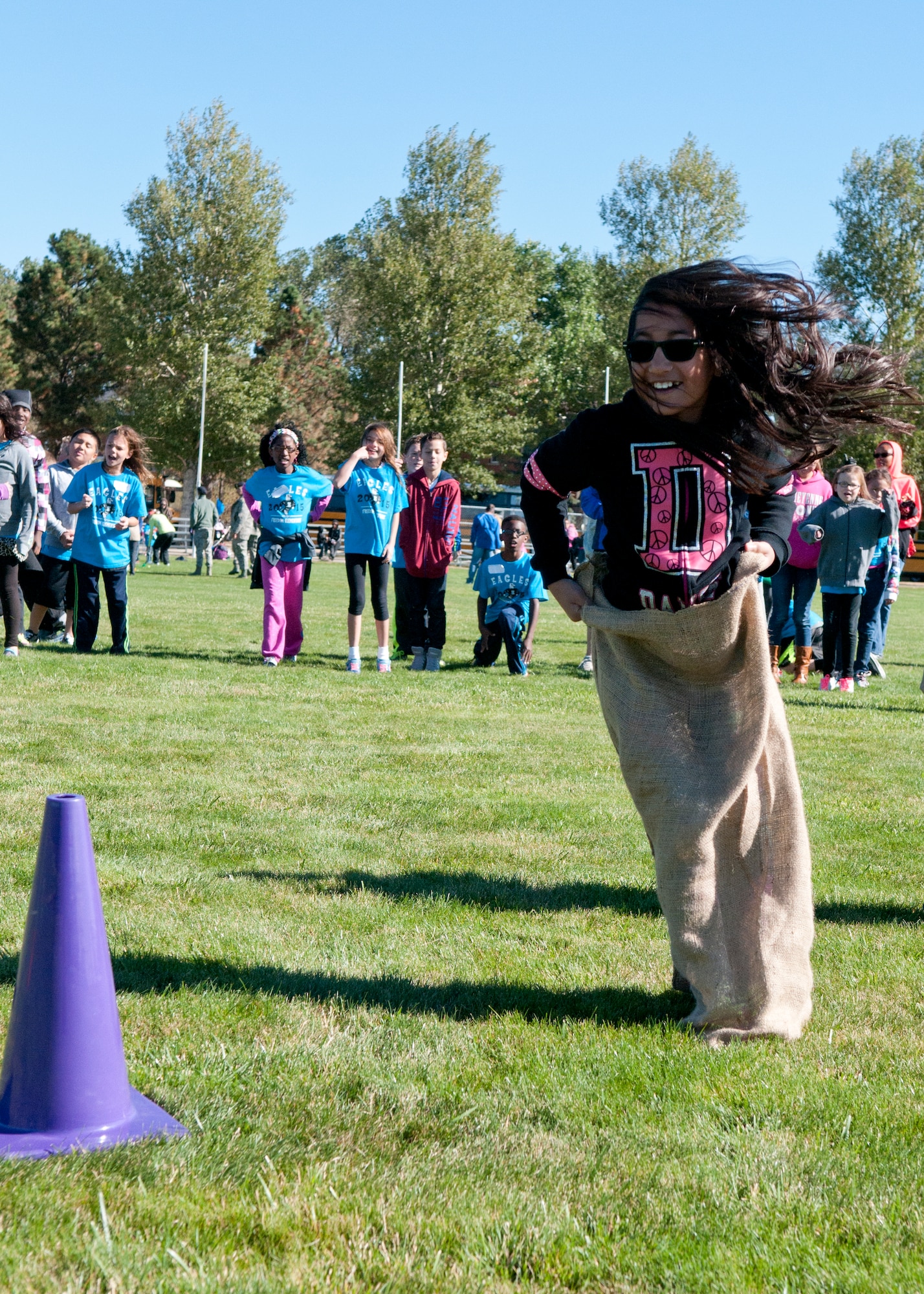 A fourth grader from Freedom Elementary School participates in the sack race Sept. 18, 2015, on the F.E. Warren Air Force Base Argonne Parade Field during the Olweus 2015/16 Anti-bullying Kick-off Fun Run on the F.E. Warren Air Force Base Argonne Parade Field. Various stations were setup for the children to enjoy including a sack race, quarter-mile run and sprints. (U.S. Air Force photo by Airman 1st Class Malcolm Mayfield)