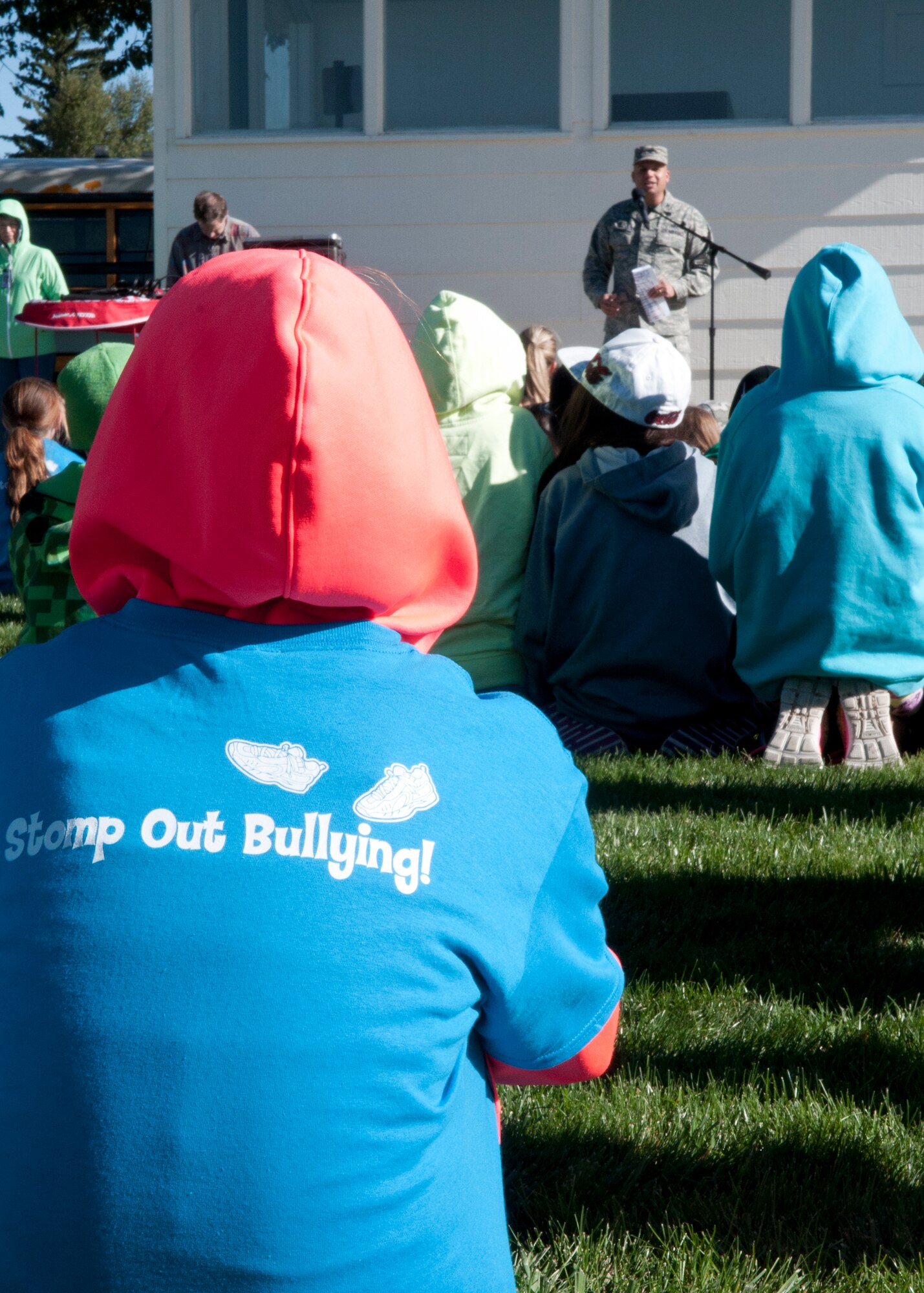 Children from Freedom Elementary School listen to Col. Frank Verdugo, 90th Mission Support Group commander, as he welcomes them to the base on the F.E. Warren Air Force Base Argonne Parade Field during the Olweus 2015/16 Anti-bullying Kick-off Fun Run. Children wore a shirt supporting the Anti-bullying event along with displaying their commitment. (U.S. Air Force photo by Airman 1st Class Malcolm Mayfield)