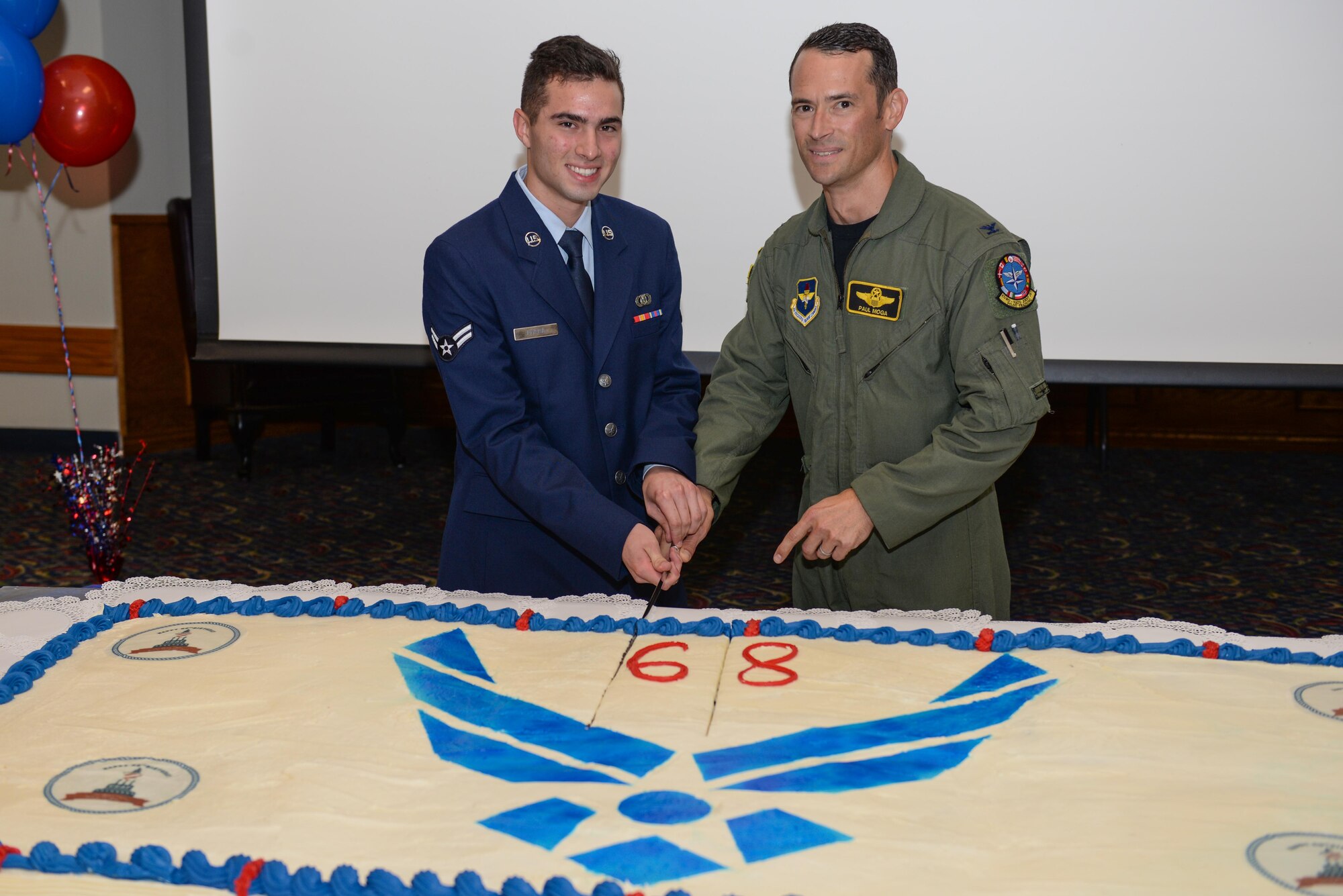 Airman 1st Class Matthew Rivera cuts a cake with Col. Paul Moga, 80th Flying Training Wing vice commander, during the 68th Air Force birthday celebration at the Sheppard Club, Sheppard Air Force Base, Texas, Sept. 18, 2015. The Air Force birthday is celebrated each year to reflect on the service and sacrifices of its ancestors. (U.S. Air Force photo/Senior Airman Kyle Gese)