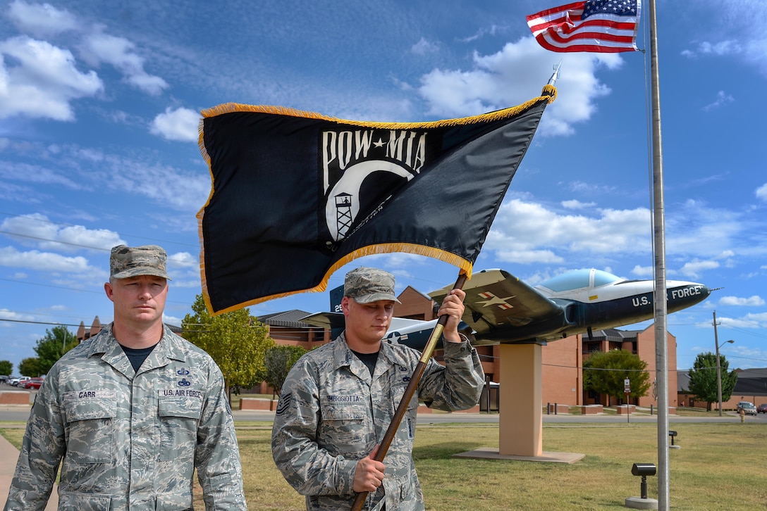 Senior Master Sgt. Dennis Carr and Tech Sgt. Mark Imbigiotta, 82nd Contracting Squadron, carry the Prisoners of War and Missing in Action flag at Sheppard Air Force Base, Texas, Sept. 18, 2015. A group of Airmen took turns carrying the flag during a 24 hour walk. More than 83,000 Americans from World War I all the way through the Gulf War are still considered missing in action. (U.S. Air Force photo/Senior Airman Kyle Gese)