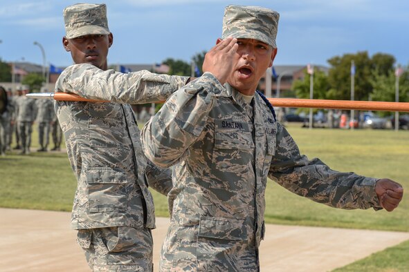 Tech. Sgt. Oscar Santana, 364th Training Squadron military training leader, calls a command to his flight after passing the 82nd Training Wing vice commander during the Prisoners of War and Missing in Action parade at Sheppard Air Force Base, Texas. Sept. 18, 2015. More than 83,000 Americans from World War I all the way through the Gulf War are still considered missing in action. (U.S. Air Force photo/Senior Airman Kyle Gese)
