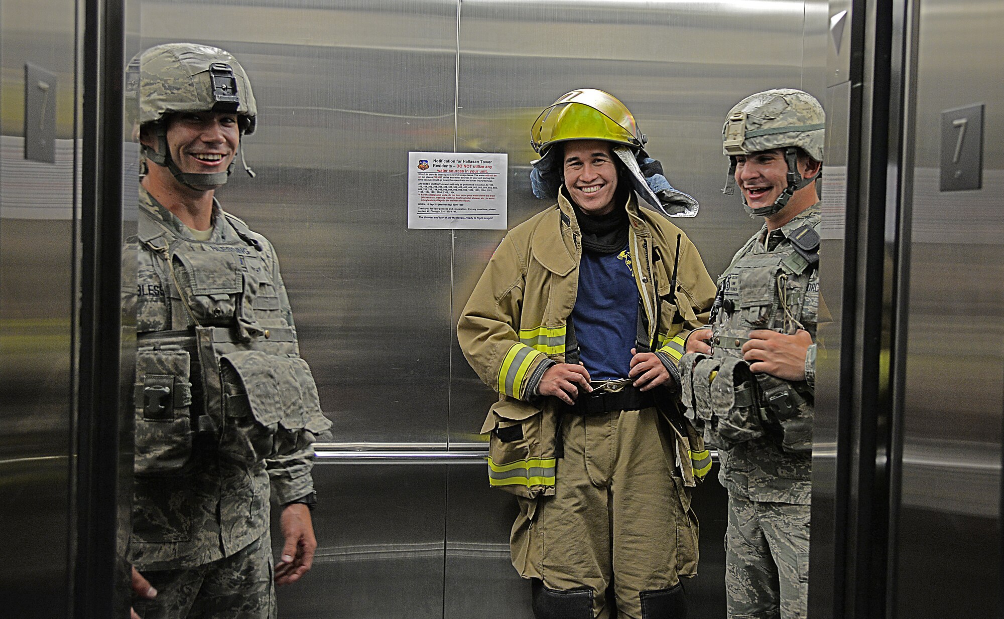 Airmen take an elevator down after climbing 13 flights of stairs during the 9/11 memorial stair climb Sept. 11, 2015, at Osan Air Base, Republic of Korea. Firefighter and security forces members from Osan AB climbed a 13-story apartment complex nine times plus two flights of stairs to reach 110 stories. (U.S. Air Force photo/Tech. Sgt. Travis Edwards)