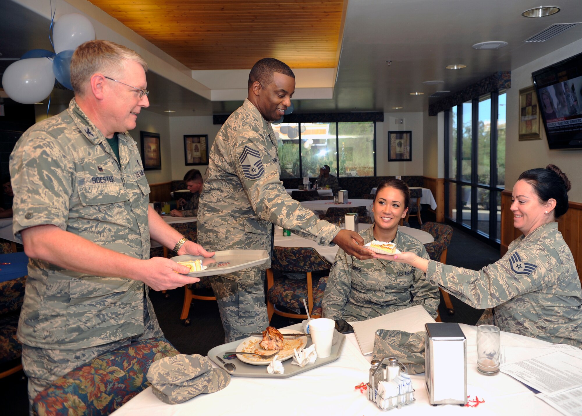 Col. Russell Boester, 56th Dental Squadron deputy commander, and Chief Master Sgt. Bruce McKenzie, 56th Medical Group command chief, hand out cake September 18, 2015 at Luke Air Force Base, Arizona. The Air Force originally began as the Army’s Aeronautical Section in 1907. After receiving the first airplane from the Wright brothers, the first aero squadron was born paving the way for the future of aviation. (U.S. Air Force photo by Staff Sgt. Marcy Copeland)   