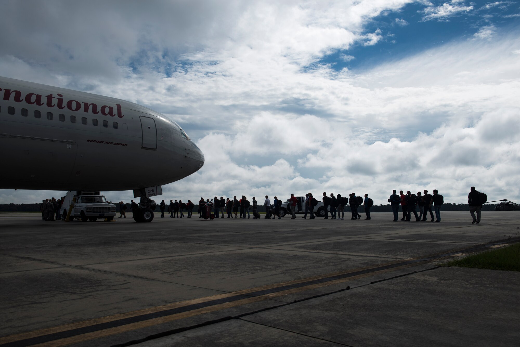 Airmen from the 23d Wing board a Boeing 767 for a deployment flight Sept. 17, 2015, at Moody Air Force Base, Ga. More than 150 Airmen from the 23d Wing departed for a deployment as part of a Theater Security Package in support of Operation Atlantic Resolve. (U.S. Air Force photo by Airman 1st Class Dillian Bamman/Released)