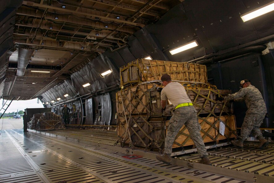 Airmen from the 23d Logistics Readiness Squadron load cargo into a C-5M Super Galaxy for a deployment Sept. 16, 2015, at Moody Air Force Base, Ga. Team Moody deployed cargo and more than 300 Airmen to northwest Europe in support of Operation Atlantic Resolve. These deployments are one of many ways the U.S. Air Force demonstrates commitment to NATO allies. (U.S. Air Force photo by Airman 1st Class Dillian Bamman/Released)